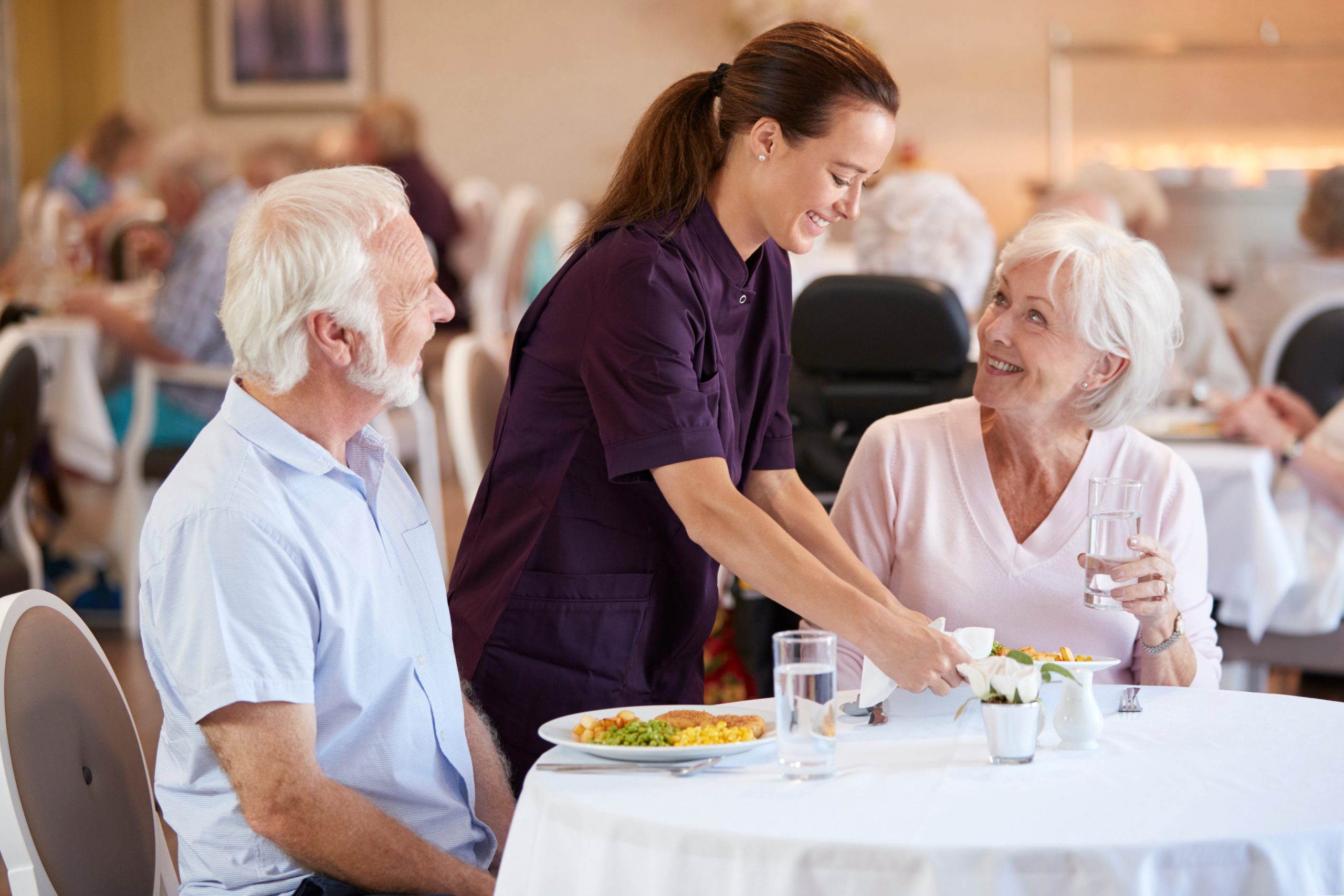 seniors smiling over a meal